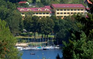a group of boats in the water in front of a building at Lipno Wellness - Frymburk C104 privat family room in Frymburk