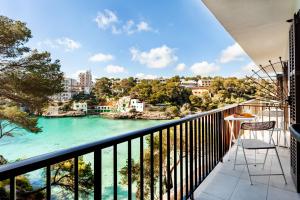 
a view from a balcony of a city with a view of the water at Apartamentos Drac in Cala Santanyi
