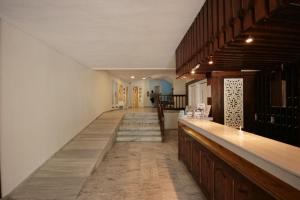 a long hallway with a bar in a house at Theodorou Beach Hotel Apartments in Kos