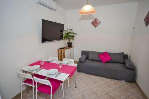 a living room with a table and a couch at Villa Nedo in Baška Voda