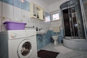 a bathroom with a washing machine and a sink at Villa Nedo in Baška Voda +63 photos