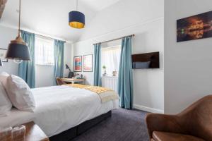 a bedroom with a bed and a chair at The Elm, Abbots Ripton in Abbots Ripton
