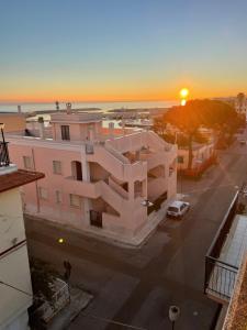 an aerial view of a building with the sunset in the background at Casa Libera in Savelletri di Fasano