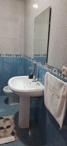 a bathroom with a sink and a toilet and a mirror at Beautiful apartment close Playa beach - Tanger N41 in Tangier +14 photos