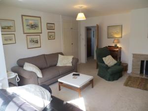 a living room with a couch and a chair at 44 Sea Lane in Hunstanton