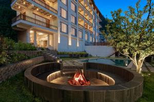 a fire pit in a yard next to a building at The Orchid Manali - a Boutique Hotel in Manāli +24 photos