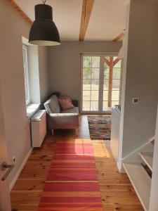 a living room with a couch and a rug at Dom w Bieszczadach in Liszna