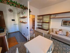 a living room with a couch and a table at Casa Della Paola by PortofinoVacanze in Santa Margherita Ligure
