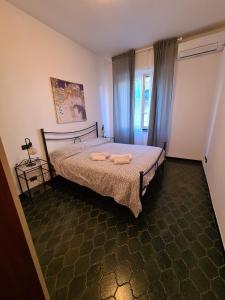a bedroom with a bed with two towels on it at Casa Della Paola by PortofinoVacanze in Santa Margherita Ligure