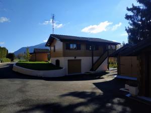 a house with a garage and a driveway at Chalet de charme entre Genève, Annecy et stations in Viuz-en-Sallaz