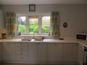 a kitchen with a sink and a window at Harecroft in Hunstanton