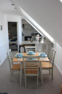 a dining room with a table and chairs in a kitchen at Sea dream lodge -coastal location/sea views/self-contained in Southerndown