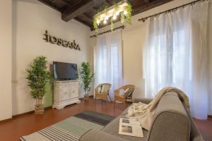 a living room with a couch and a tv at Mamo Florence - Feelgood Apartment in Florence