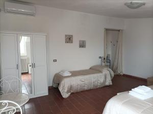 a hotel room with two beds and a balcony at Dimora Erminia in Polignano a Mare