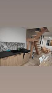 a kitchen with a sink and a wooden table at il fait bon vivre classé 3 étoiles in Montcuq