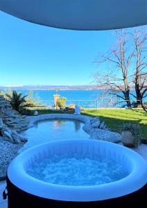 a hot tub with a view of the water at SunVilla in Koper