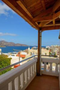 a balcony with a view of a city and the ocean at Beautiful newly apt with sea view, near the center in Agios Nikolaos