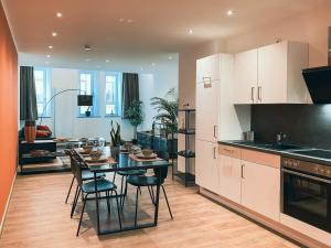 a kitchen and dining room with a table and chairs at Brunnen Apartments in Nuremberg