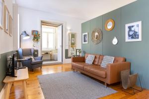 a living room with a couch and a chair at Cozy Studio Apartment in Porto