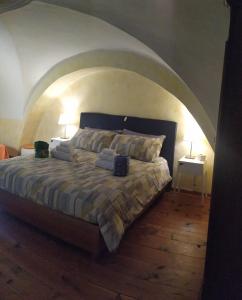 a bedroom with a large bed with an arched ceiling at My Loft Catania in Catania