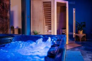 a blue tub filled with water in a room at Penzion a Restaurace v Zátiší in Horní Lhota