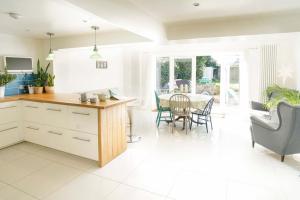 a kitchen and dining room with a table and chairs at Seashells - Bembridge in Bembridge