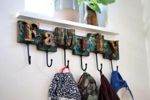 a rack of clothes hanging on a wall at Seashells - Bembridge in Bembridge
