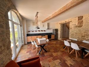 a living room with a wooden table and chairs at LE MOULIN DU VIVIER in Saint-Martin-Lalande