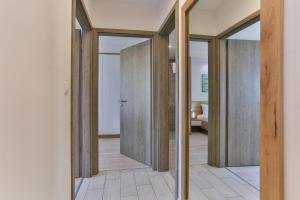a hallway with sliding doors in a house at Admiral Luxury III Apartman By BLTN in Siófok +32 photos