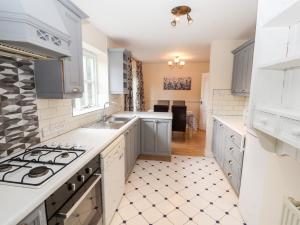 a kitchen with white cabinets and a stove top oven at 45 Benton in Chester