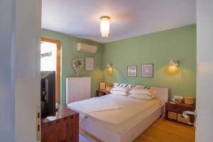 a bedroom with a bed and a television in it at Heraklion-Knossos Luxury Home in Knossós