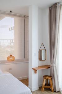 Postel nebo postele na pokoji v ubytování Haksabai Hotel Chiangrai โรงแรมฮักสบาย เชียงราย