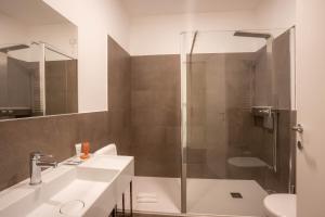 a bathroom with a shower and a sink and a toilet at V Hotel in Ancona