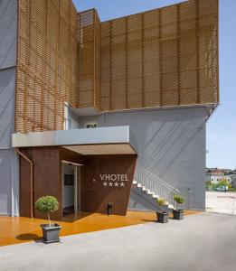 a building with a sign on the side of it at V Hotel in Ancona