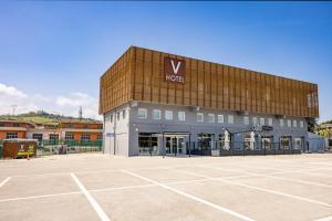 a large building with a sign on the front of it at V Hotel in Ancona