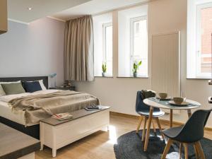 Кровать или кровати в номере Brunnen Apartments