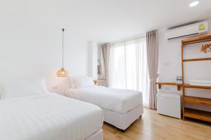 Postel nebo postele na pokoji v ubytování Haksabai Hotel Chiangrai โรงแรมฮักสบาย เชียงราย