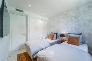 A bed or beds in a room at HigueronRentals Skotte