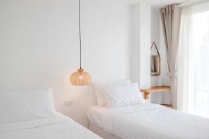 Postel nebo postele na pokoji v ubytování Haksabai Hotel Chiangrai โรงแรมฮักสบาย เชียงราย