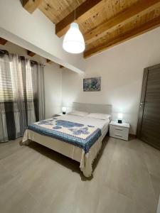 a bedroom with a bed in a room with wooden ceilings at Il Bocciolo - Locazione turistica in Scilla