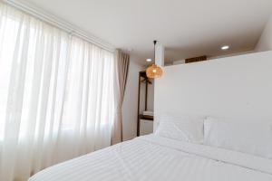Postel nebo postele na pokoji v ubytování Haksabai Hotel Chiangrai โรงแรมฮักสบาย เชียงราย