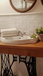 a bathroom sink with a faucet and a mirror at Agriturismo La Casetta - ospitalità rurale familiare in Montese