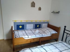 ein kleines Schlafzimmer mit einem Holzbett mit blauer und weißer Bettwäsche in der Unterkunft Apartmány Mirka a Maťko in Donovaly