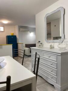 a living room with a white dresser and a mirror at Casa Maremma in Castiglione della Pescaia