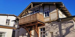 a house with a balcony on the side of it at Ferienwohnung in Heringsdorfer Villa Koje in Bansin