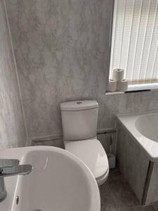a bathroom with a white toilet and a sink at Modern 2 bed sleep 5 close to Anfield Stadium in Liverpool