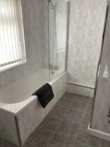 a bathroom with a shower and a bath tub at Modern 2 bed sleep 5 close to Anfield Stadium in Liverpool