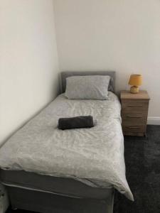 a bed with a pillow on it in a bedroom at Modern 2 bed sleep 5 close to Anfield Stadium in Liverpool