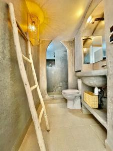 a bathroom with a ladder leading to a toilet and a sink at Riad Dar Zayna in Essaouira