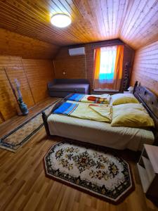 a bedroom with a bed and a couch in a room at Kriszta apartman in Balatongyörök +26 photos